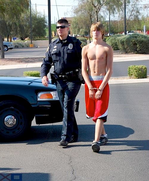 handcuffed in red shorts